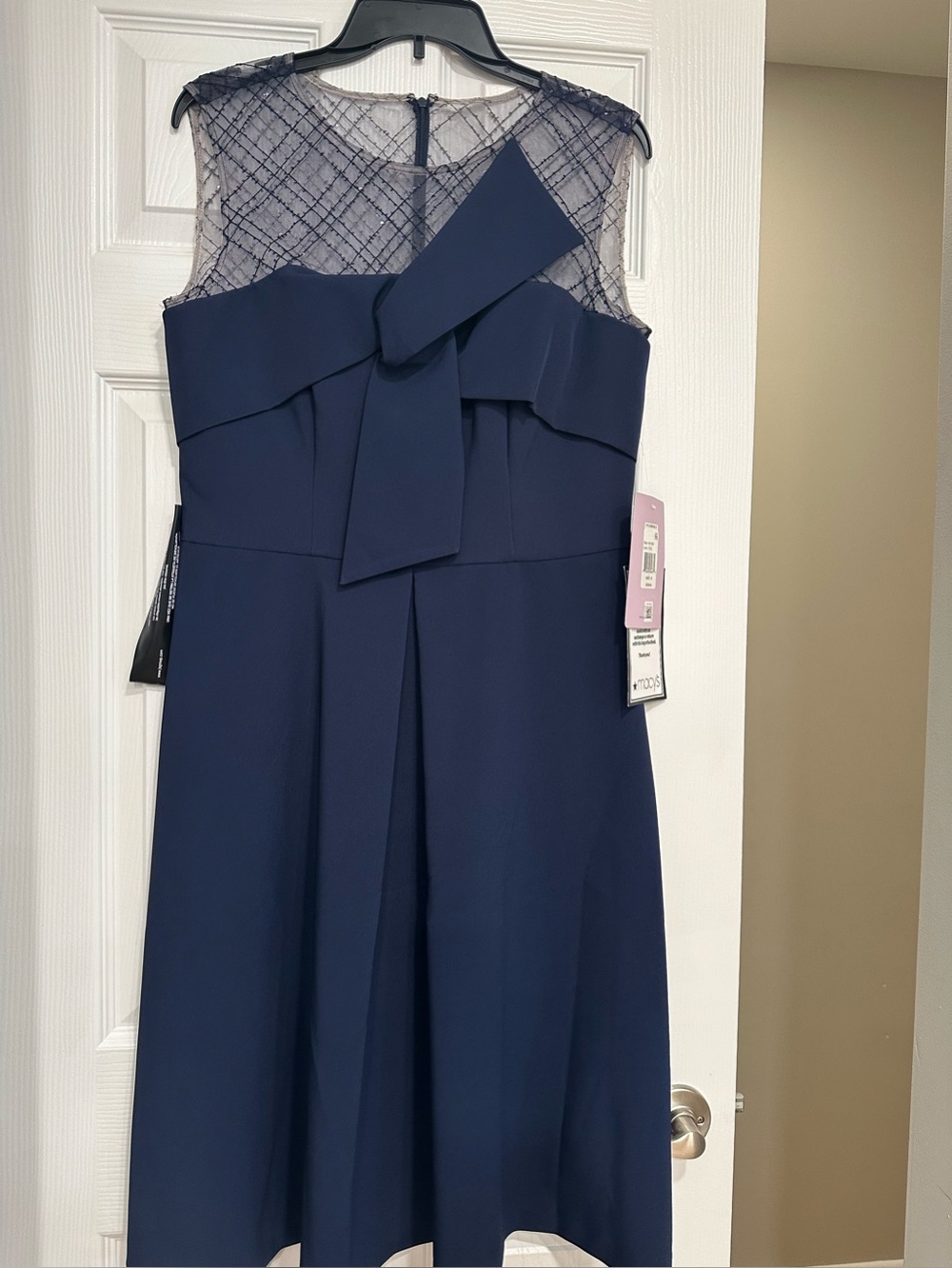 JS Collections Navy Dress with Front Bow Accent. Sheer mesh jewel neck.